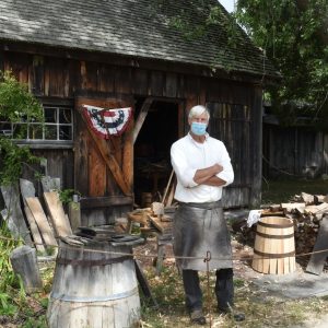 Ron Cooper standing in front of his shop at Strawbery Banke
