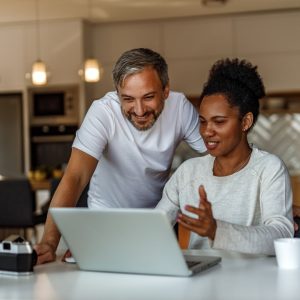 Man and Woman interacting with laptop and camera