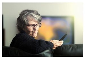 Woman frustrated with TV remote