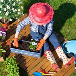 Woman works in sunny garden