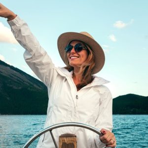 Woman on boat with hat and sunglasses
