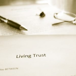 living trust document with pen and glasses
