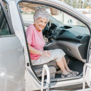 Woman smiles from passenger seat