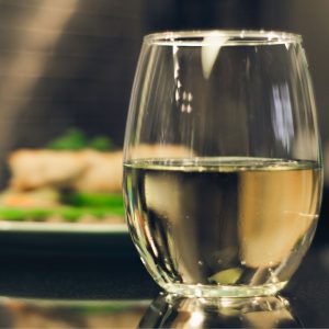 Glass of white wine in foreground