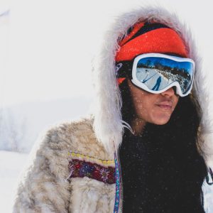 woman wearing snow goggles and winter coat