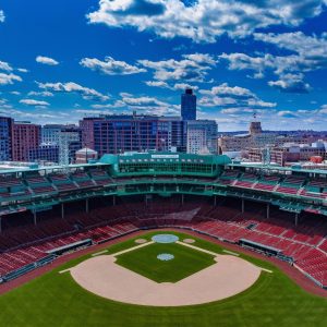 Overhead shot of Fenway park, including the red seats and the boxes behind home plate