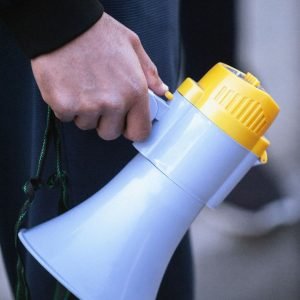 Hand holding a bullhorn