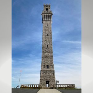 A shot from the ground of the Pilgrim Monument, a massive monolith with turrets on top