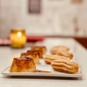 Plated dessert of flan and churros