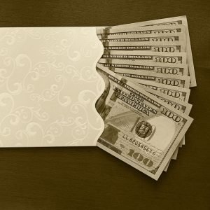 an envelope is filled with $100 bills fanned out