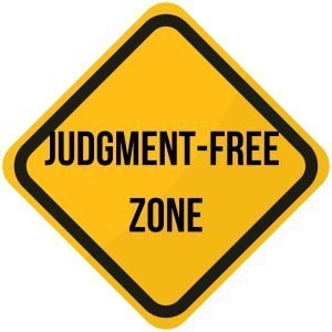 A yellow sign (like a road sign) with a black border says "judgment-free zone"