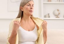 The Rise of Third-party Provided Menopause Support woman experiencing hot flash as a symptom of menopause