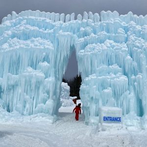 Dramatic shot of girl walking through entrance of Ice Castle