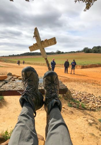 Stopping to rest one's feet while walking the Camino de Santiago