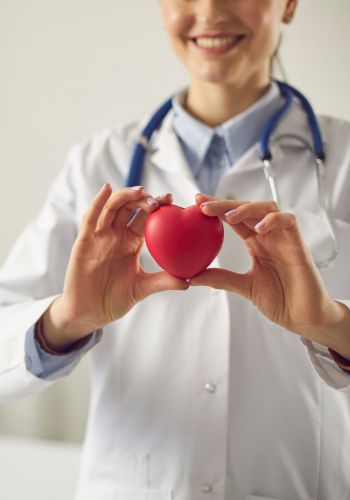 Medical professional holding heart-shaped stress toy