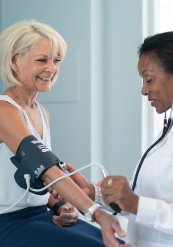 Mature woman getting blood pressure checked