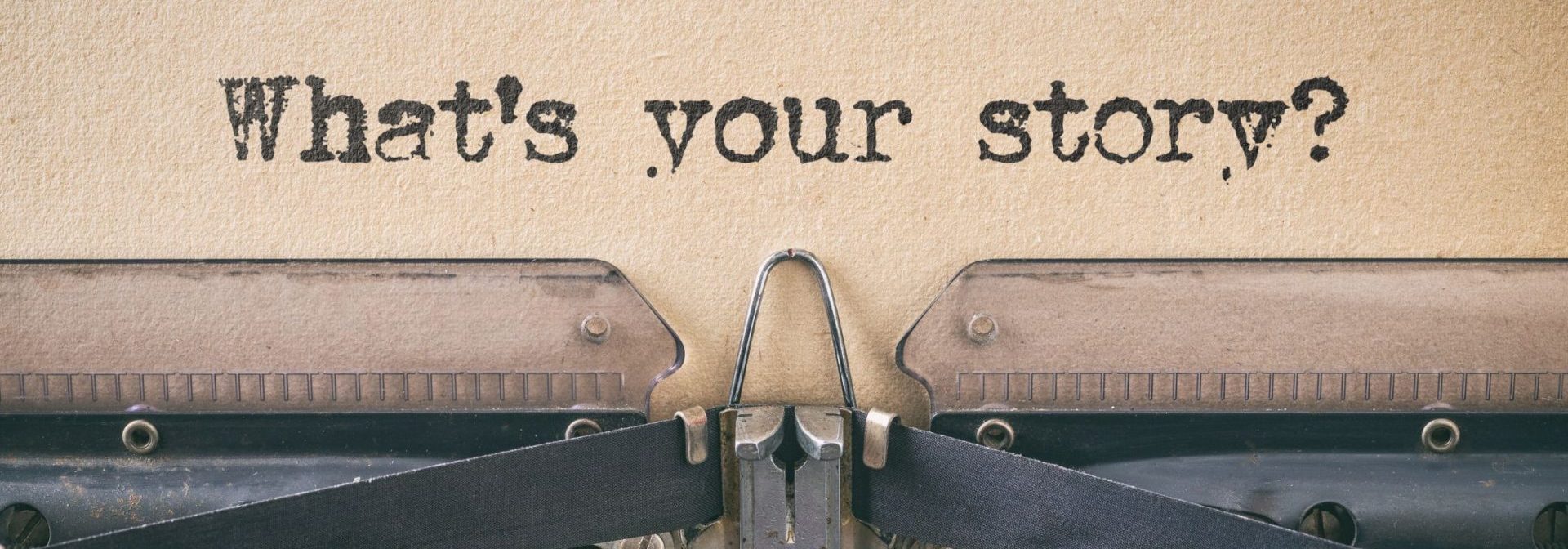 old typewriter with words "What's your story?" typed