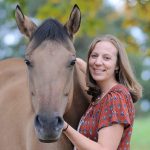 Katie Navarra petting a horse