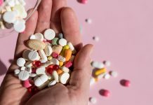 Aging, and Overmedicated hand holding multiple pills- aging and overmedicating featured image