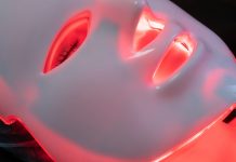 At-Home Spa Day Trends from “Skinimalism” to Infrared Tech Woman using a red light phototherapy mask - featured image for at home spa trends