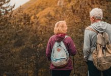 Why Fall May Be a Sweet Spot for Travel Senior couple on autumn hike_Fall Travel featured image