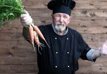 The Fall ‘Superfoods’ You’re Probably Overlooking senior chef holding bunch of carrots
